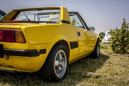 136574885-rear-view-of-a-vintage-yellow-fiat-a-sporty-with-a-strong-character-.jpg